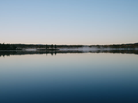 Early Morning Fog Over Calm Lake