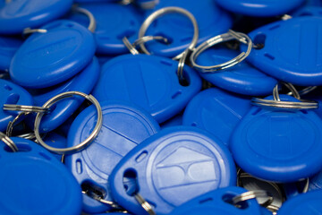 Close up a bunch of blue electronic component RFID key fobs. Proximity key fobs, RFID technology, selective focus