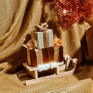 sleigh with some gift boxes ties with golden ribbons