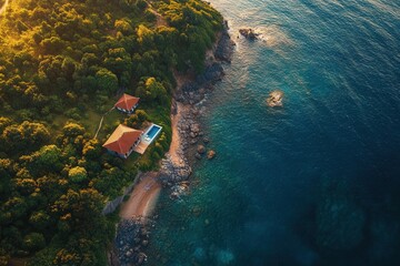Aerial view of secluded beach house with pool.