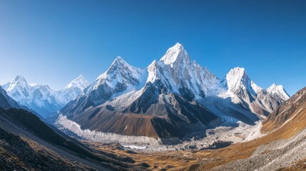 Obraz premium A panoramic view of a rugged mountain range with snow-capped peaks under a clear blue sky, Mountain landscape scene, Majestic natural style