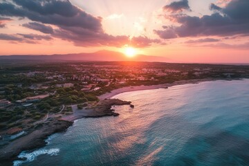 Fototapeta premium Coastal sunset over town, aerial view.