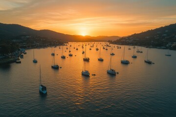 Fototapeta premium Golden sunset over calm bay with numerous sailboats.