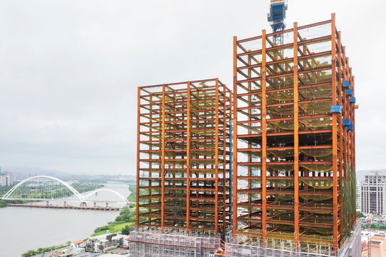 High-Rise Buildings Under Construction Near River and City Skyli
