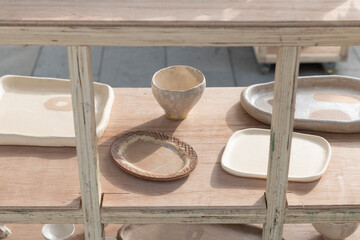Handcrafted Ceramic Plates and Bowls on Wooden Table