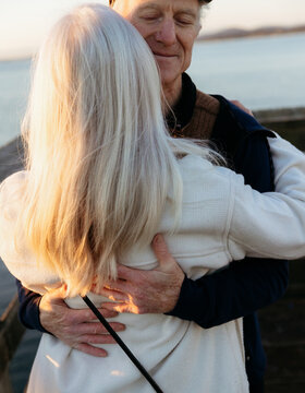 Elderly Couple Sharing a Tender Embrace by the Sea