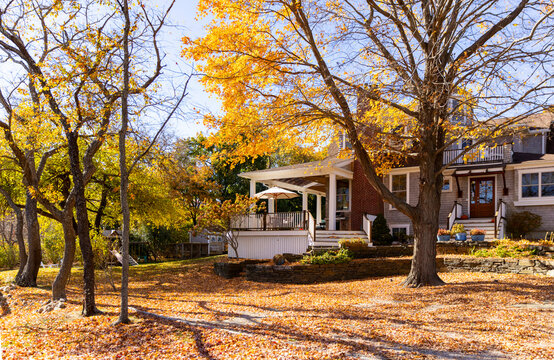 House porch with colorful fall foliage backyard 