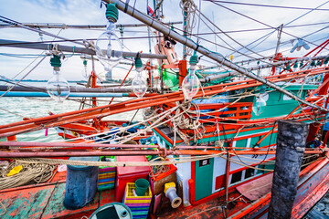 Chonburi, Thailand - November, 18, 2024 : Fishing Bulbs Hanging on Wooden Structures with Colorful Details in a Thai Port at Chonburi, Thailand.