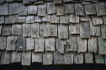 Wooden roof tiles used in Asian building weathered and bleached through sun and rain