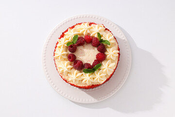 Red velvet cake with berries on white background, top view