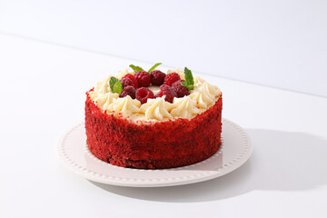 Red velvet cake with berries on white background