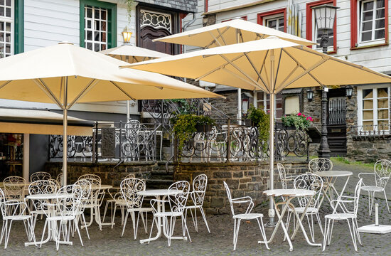 Old town with empty chairs in a cafe early in the morning