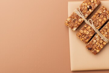 Healthy Granola Bars with Oats and Nuts on Brown Background