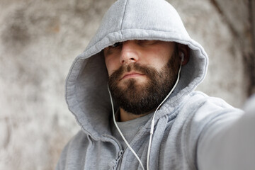 man in studio puts ear phones out to music.