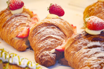 Delicious Croissants Delicately Topped with Fresh Strawberries and Cream
