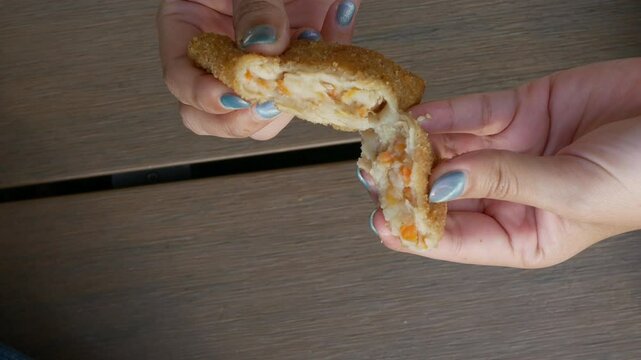 Fried Risoles getting open up with mayonnaise inside.Risol Mayo is a typican Indonesian snack food. Looks like Coxinha de Galinha