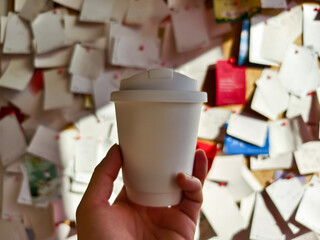 hand holding a cup of coffee