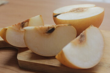 sliced apple on a wooden board