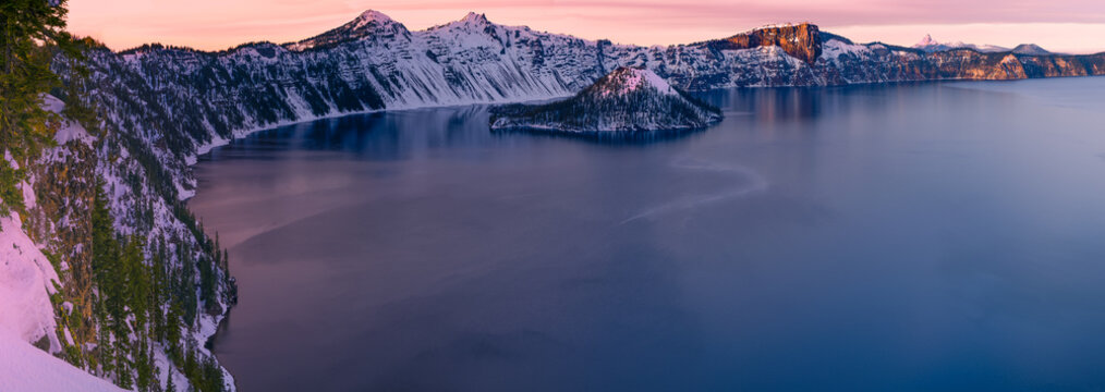 Winter at the Crater Lake National Park - snow capped mountains and frozen lake at sunset. - Powered by Adobe