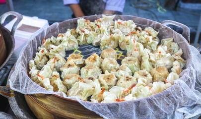Dimsum with various flavors in bamboo steamer siomay. Dim sum with mentai sauce, cheese dim sum, seafood dim sum being steamed