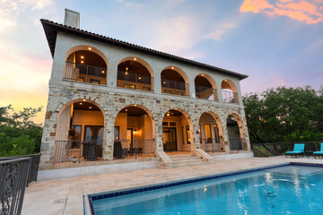 Obraz premium Beautiful stone villa with pool at sunset in a tranquil setting