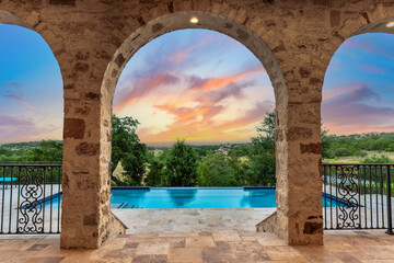 Stunning sunset view from a luxurious outdoor space overlooking a pool