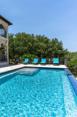Relaxation by the Infinity Pool Beneath a Clear Blue Sky