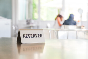 Reserved sign on a table in restaurant with bokeh,Restaurant reservation service,copy space..