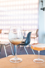 Glass of two Mocktail on table,female hand swirling red wine in wine glass,table for two,Friends cheering with wineglasses,eating and holidays concept.