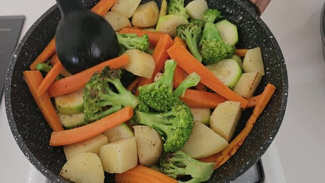cooking vegetables on fire with fresh olive