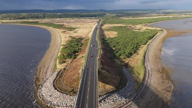 Cars flowing on Dornoch firth bridge aerial view north of scotland