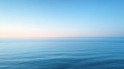 Serene Blue Ocean Under Clear Sky at Dusk with Gentle Waves