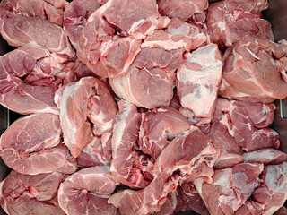 Fresh Raw Pork Cuts Piled High in a Butcher's Display Tray