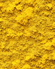 A vibrant yellow texture resembling sand or powder.