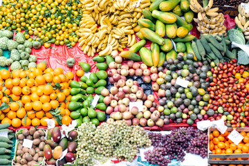 vibrant colors and lively atmosphere of the Mercado dos Lavradores in Funchal, Madeira, showcasing fresh produce, exotic fruits, and bustling market activity