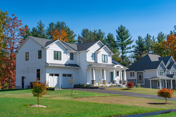 colorful autumn trees and new built luxury houses in residential area