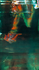 Aged foil. Old film overlay. Green orange color stains light flares dust scratches damaged uneven stripes metallic surface defect spots texture illustration art abstract background.