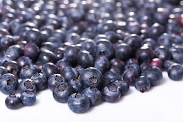 Healthy vitamin food. Ripe berries of fresh sweet bilberries on white background..