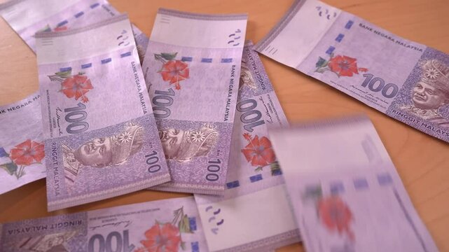 Throwing piles of Ringgit