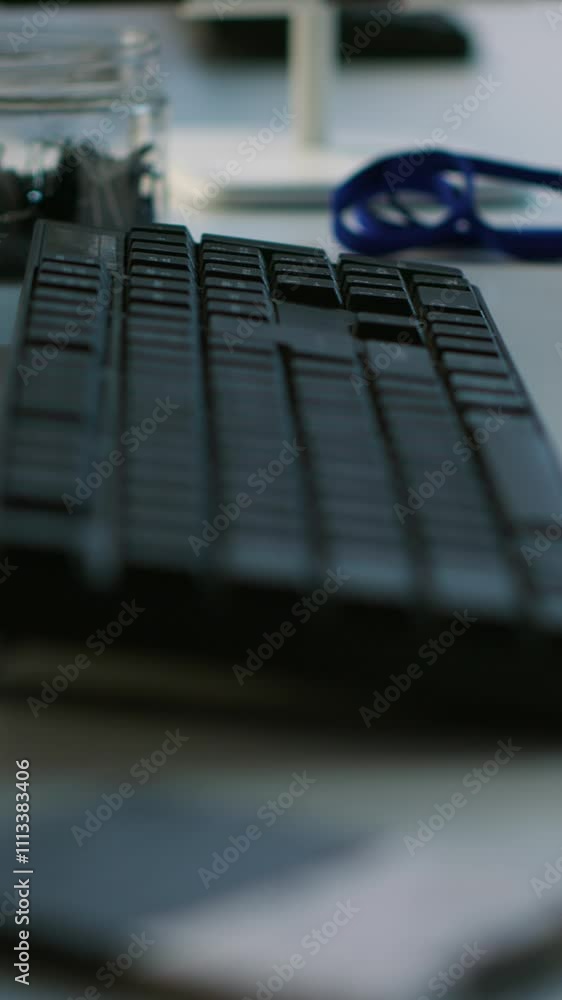 Poster vertical video close up of computer peripherals on server room desk used by employees working to ens