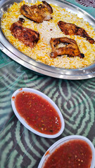 Arabian dish of chicken kabsa rice in a big plate