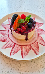 Cheesecake with blueberry jam, strawberry, blackberry, raspberry, lingonberry, mint