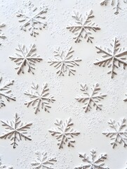 A textured white surface featuring various snowflake designs.