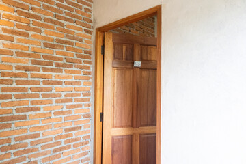 Wooden front door with Red brick wall texture background,modern house in city,japan or korea home,Old brick blocks wall,copy space, brickwork exterior mockup.