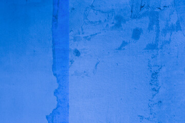 Unfinished blue plaster on the wall.