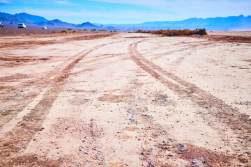 Tire Tracks in Nevada Desert with Distant Mountains Low Perspective