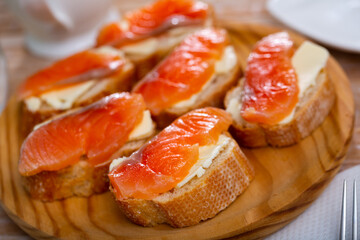 Sandwiches with salmon and butter on a white plate