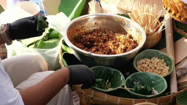 Making Miang Kham (traditional Southeast Asian herbal snack from Thailand and Laos), Traditional Thai snack. It&rsquo;s a snack containing different ingredients of herbs and vegetables. 