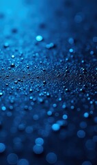 Abstract close-up of water droplets on a textured surface, showcasing a serene blue hue, perfect for backgrounds or creative designs in various media.
