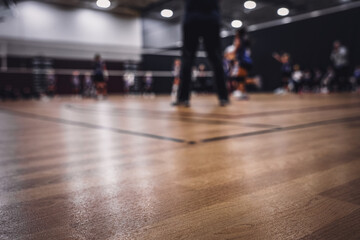 low level selective focus on gym floor at a youth volleyball match 